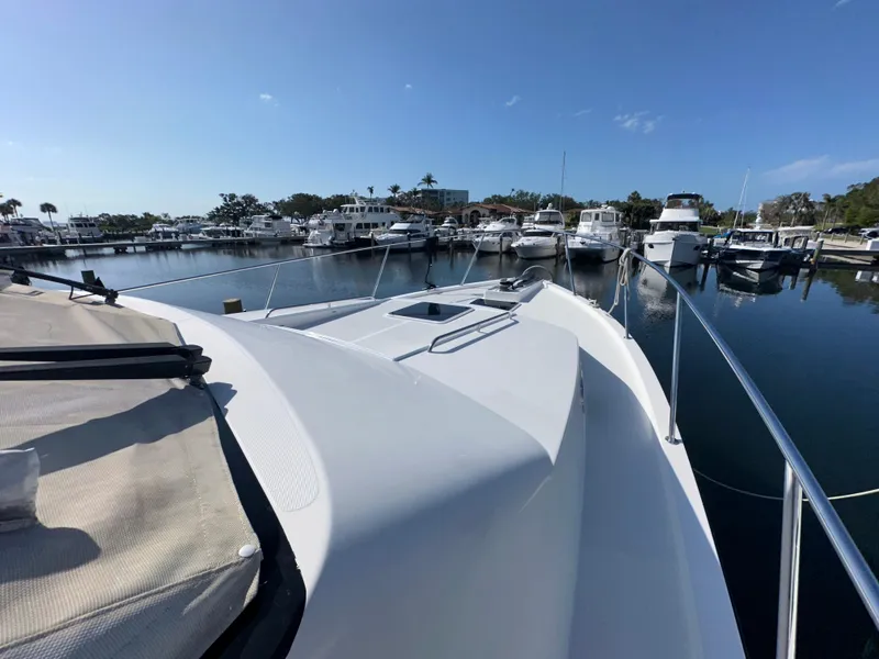 Slide: The Image of 2003 Pacific Mariner 65 SE Motoryacht docked in a sunny marina. - 48