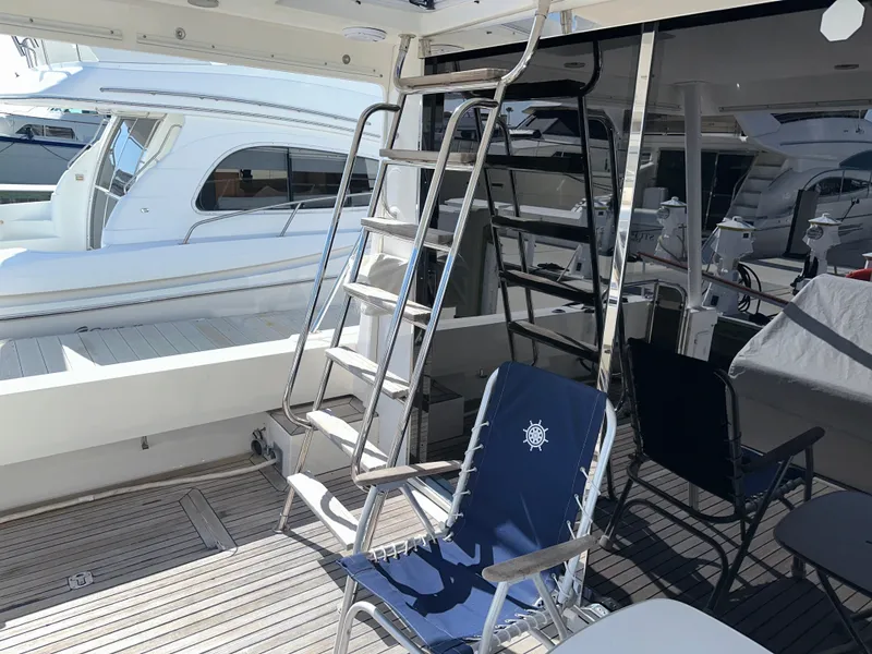 Slide: The Image of 2003 Pacific Mariner 65 SE Motoryacht deck with ladder and seating area. - 49