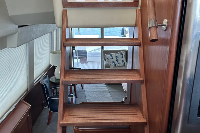 Slide: The Image of Interior of 2003 Pacific Mariner 65 SE Motoryacht with wooden stairs and elegant decor. - 51
