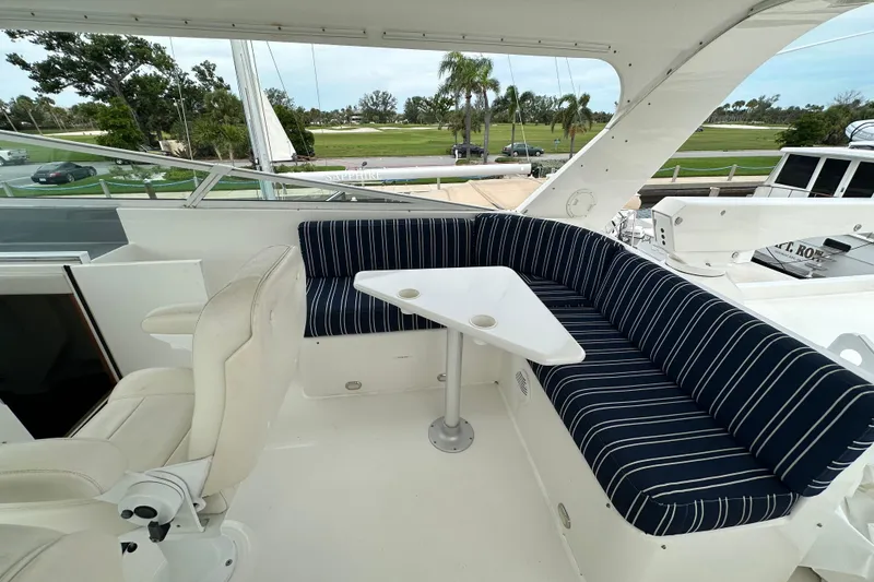 Slide: The Image of 2003 Pacific Mariner 65 SE Motoryacht with striped seating and table on deck. - 57