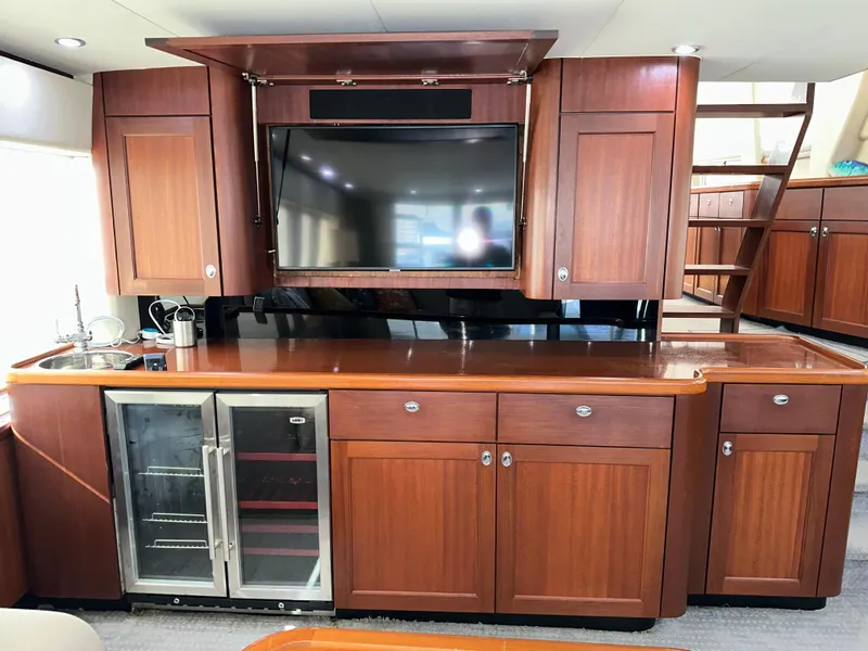 Slide: The Image of Luxurious interior of 2003 Pacific Mariner 65 SE Motoryacht with wooden cabinetry and built-in TV. - 9