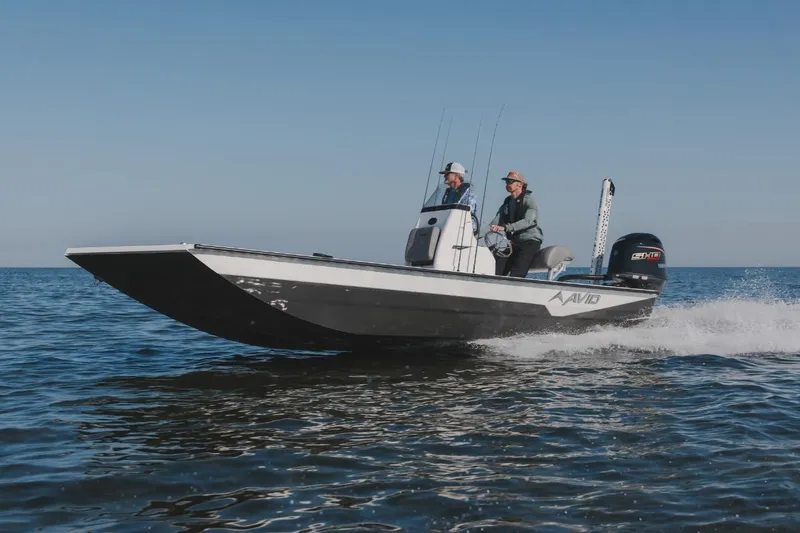The Image of 2026 Avid 21 FST boat cruising on open water with two passengers. - 1