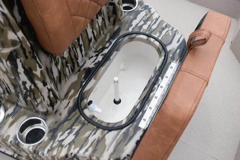 Slide: The Image of Camouflage-patterned interior of 2026 Avid 21 FST boat with brown seating and cup holders. - 8