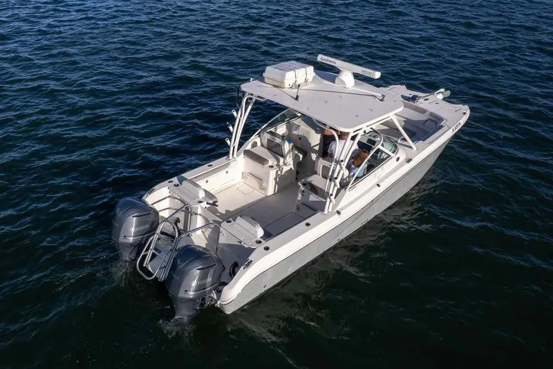 Slide: The Image of 2017 World Cat 295 DC boat on open water, featuring dual Yamaha engines. - 12