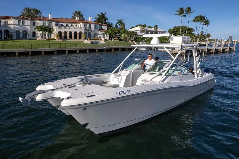 Slide: The Image of 2017 World Cat 295 DC boat cruising near luxury waterfront homes. - 17