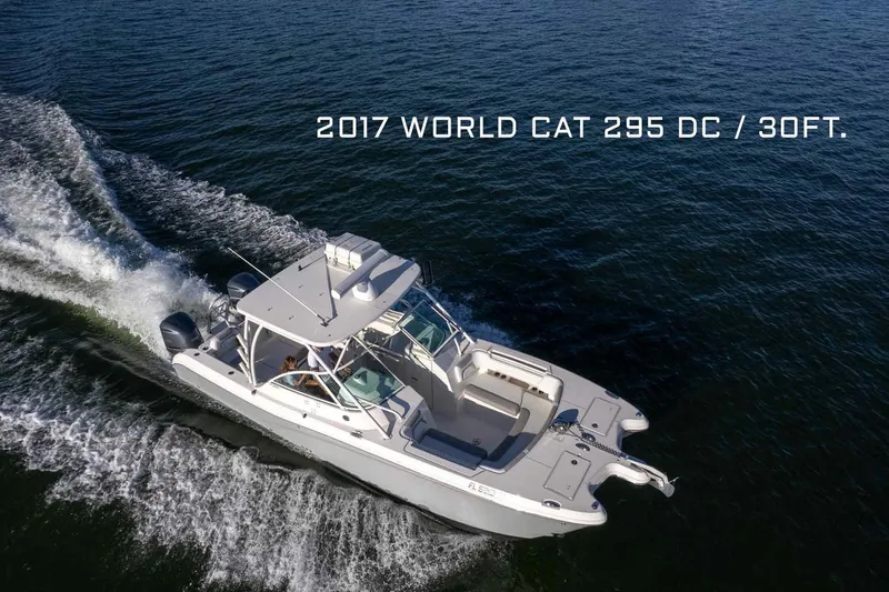 Slide: The Image of 2017 World Cat 295 DC boat cruising on open water, aerial view. - 2