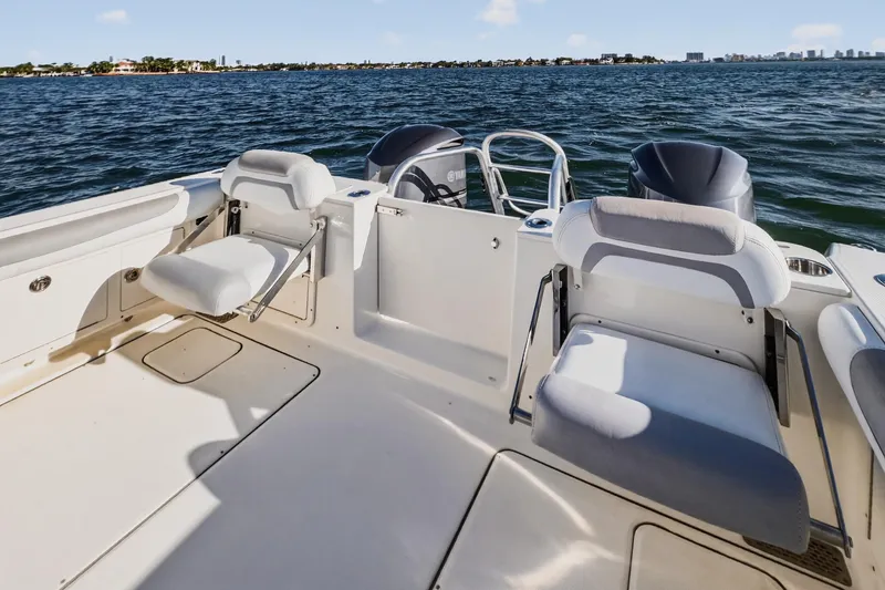 Slide: The Image of 2017 World Cat 295 DC boat interior with seating, on a sunny day at sea. - 25