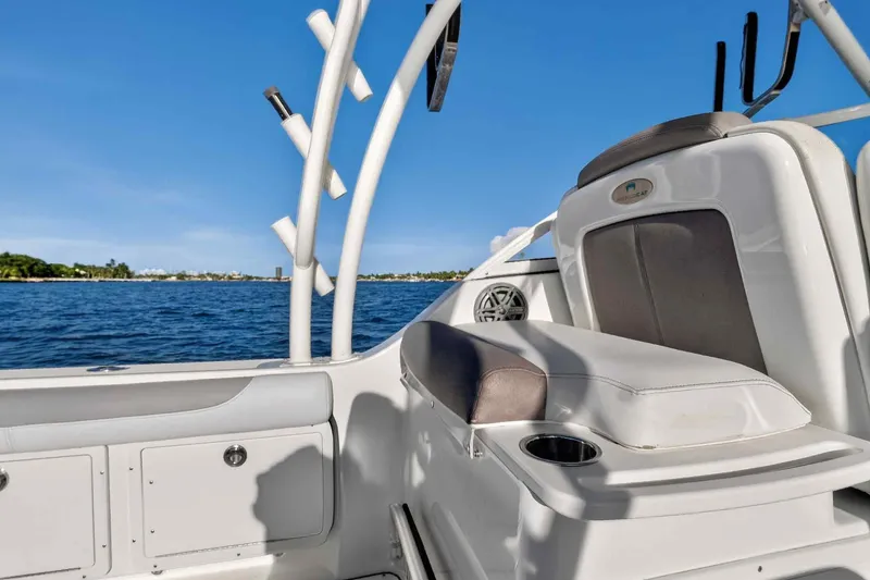 Slide: The Image of 2017 World Cat 295 DC boat interior with seating, cup holder, and ocean view. - 27