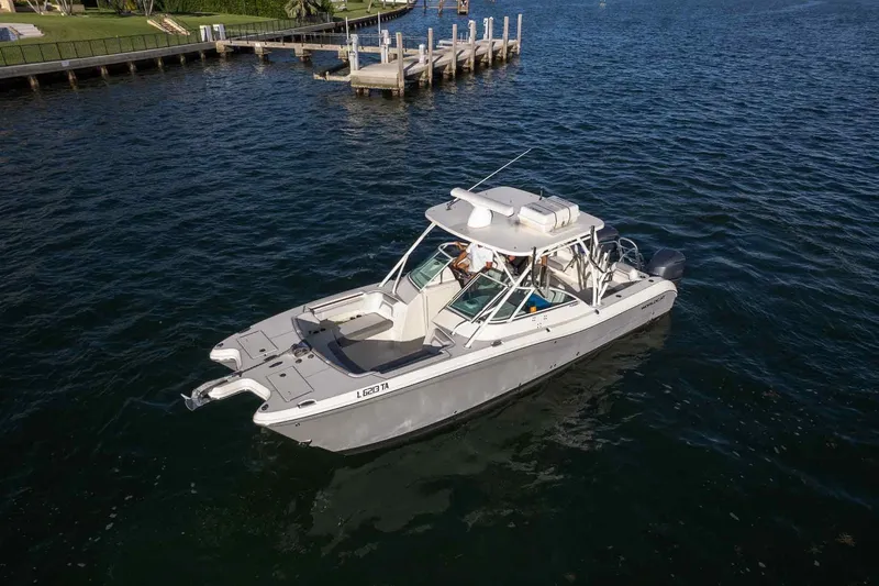Slide: The Image of 2017 World Cat 295 DC boat on water near a dock, aerial view. - 33