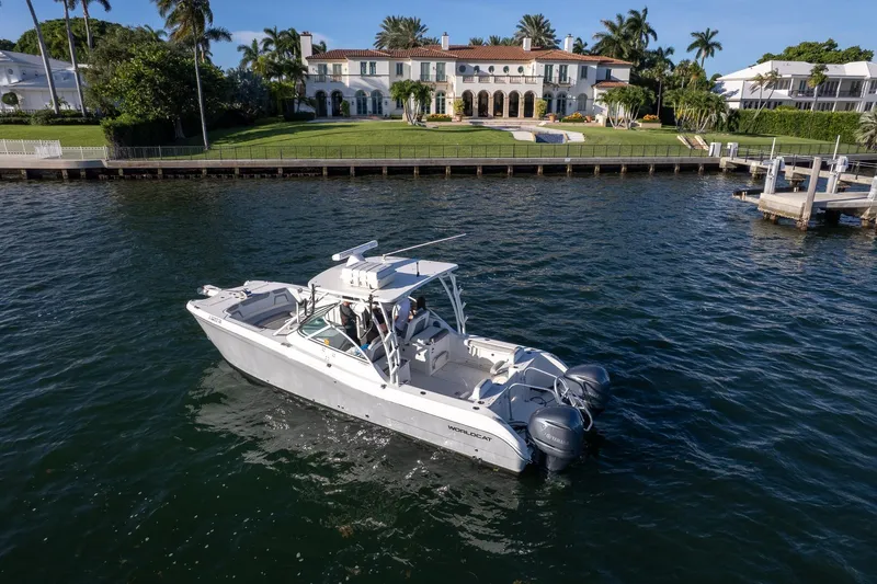 Slide: The Image of 2017 World Cat 295 DC boat cruising near luxurious waterfront mansion. - 36