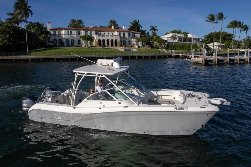 Slide: The Image of 2017 World Cat 295 DC boat cruising near luxury waterfront homes. - 4