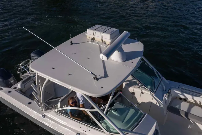 Slide: The Image of 2017 World Cat 295 DC boat on water, aerial view, showcasing deck and seating area. - 9