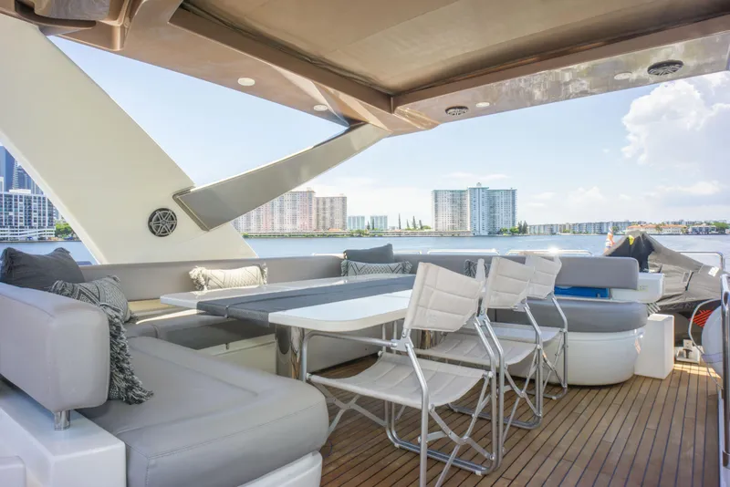 Slide: The Image of Luxurious 2015 Ferretti Yachts 750 deck with seating, overlooking waterfront cityscape. - 15