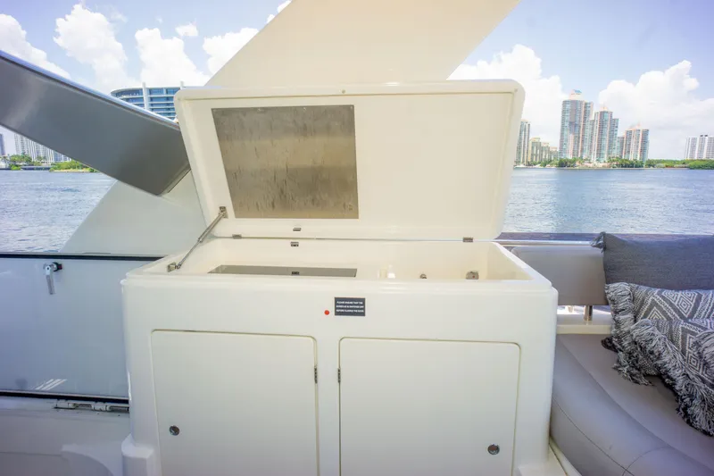 Slide: The Image of 2015 Ferretti Yachts 750 deck with open storage compartment, city skyline in background. - 16