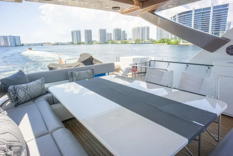 Slide: The Image of Luxurious 2015 Ferretti Yachts 750 with elegant outdoor seating and scenic waterfront view. - 18