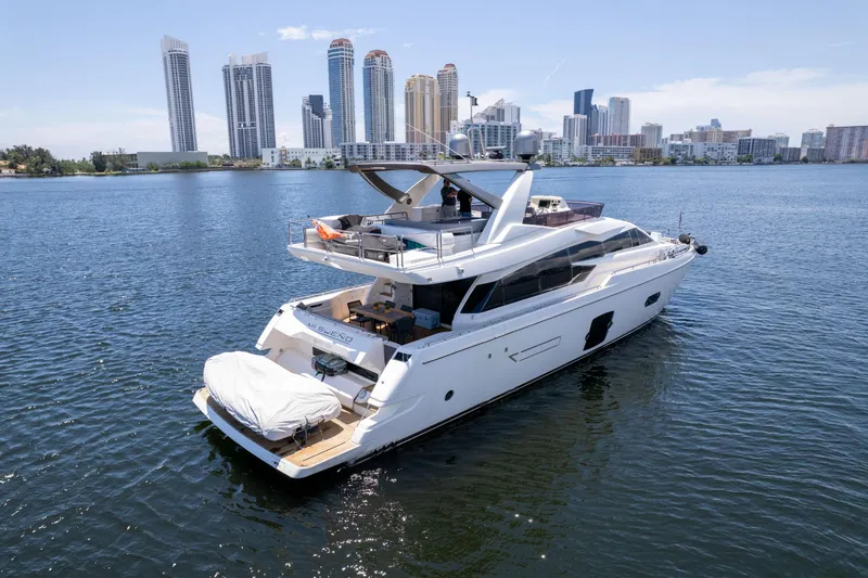 Slide: The Image of Luxury 2015 Ferretti Yachts 750 on water with city skyline backdrop. - 2