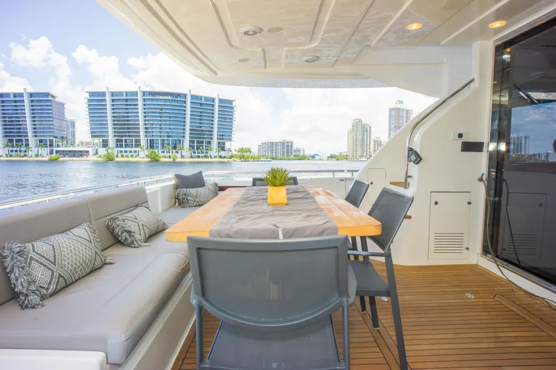 Slide: The Image of Outdoor dining area on 2015 Ferretti Yachts 750, featuring modern seating and waterfront view. - 21