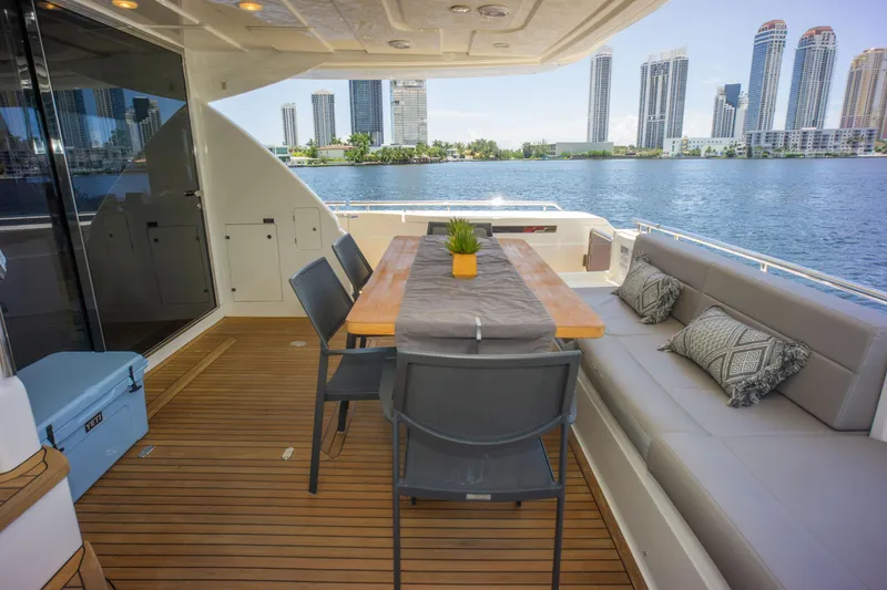 Slide: The Image of Luxurious 2015 Ferretti Yachts 750 deck with dining area, overlooking waterfront cityscape. - 24