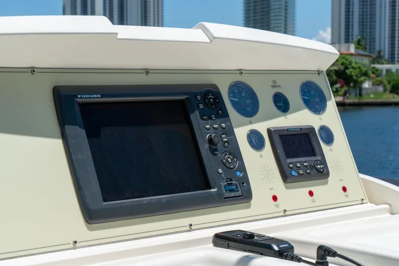 Slide: The Image of Control panel of a 2015 Ferretti Yachts 750 with navigation instruments and cityscape background. - 29