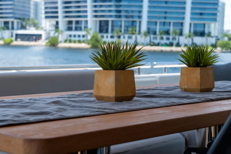 Slide: The Image of Outdoor table with plants on a 2015 Ferretti Yachts 750, cityscape in background. - 35