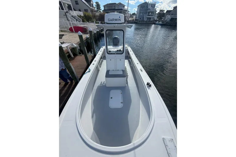 Slide: The Image of 2018 Steiger Craft 23 boat docked, featuring Garmin equipment, in a residential canal setting. - 10