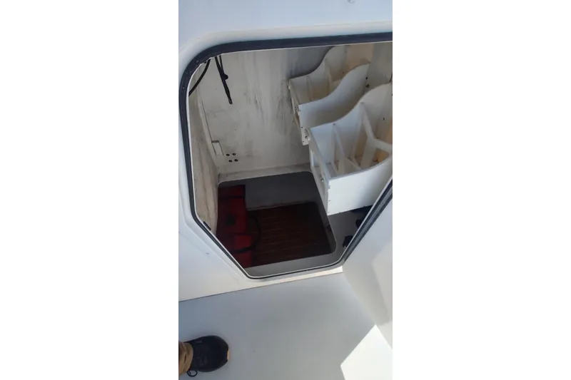 Slide: The Image of 2018 Steiger Craft 23 cabin interior with storage compartments and wooden flooring. - 15
