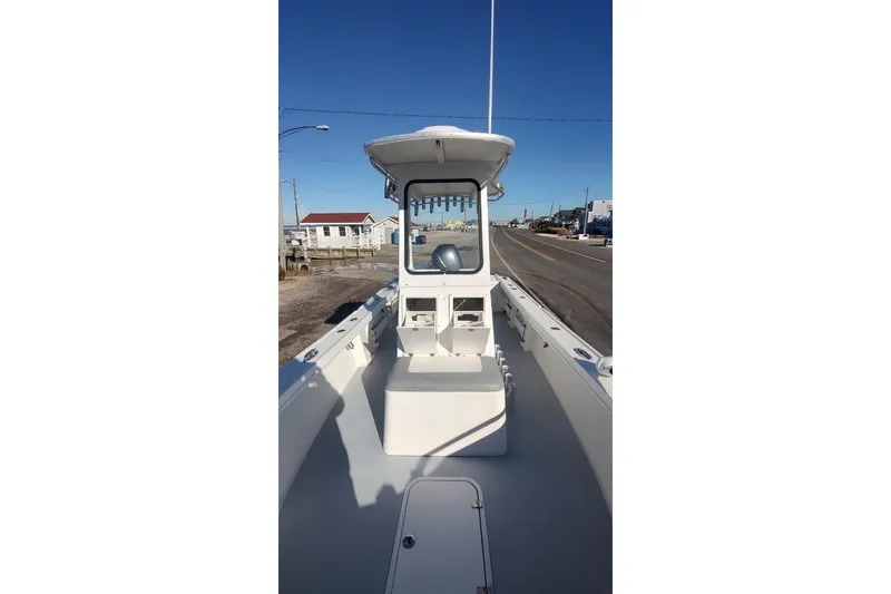 Slide: The Image of 2018 Steiger Craft 23 boat with center console, docked under clear blue sky. - 16