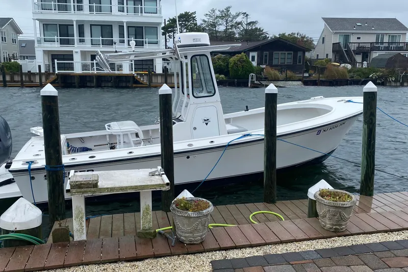 Slide: The Image of 2018 Steiger Craft 23 boat docked by waterfront homes on a cloudy day. - 9
