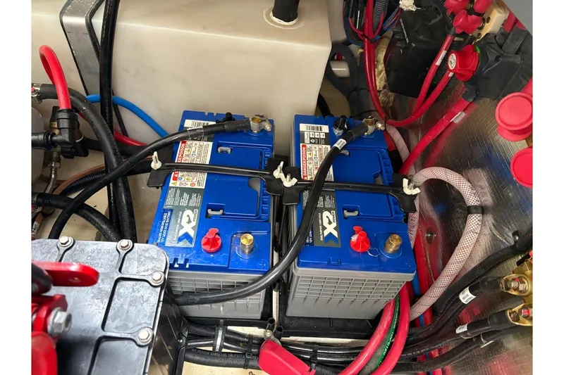 Slide: The Image of Battery compartment of 2021 Regal 26 Express boat with wiring and connections. - 14