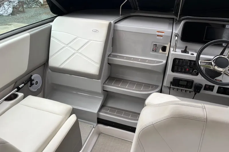 Slide: The Image of 2021 Regal 26 Express boat interior with helm, seating, and control panel. - 22