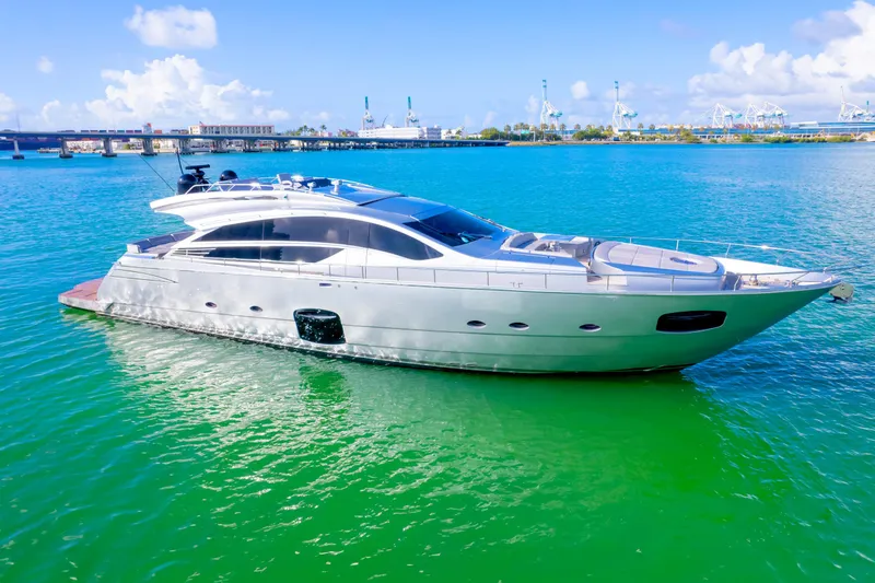 Slide: The Image of Luxurious 2013 Pershing 82 yacht cruising on vibrant blue-green waters. - 10