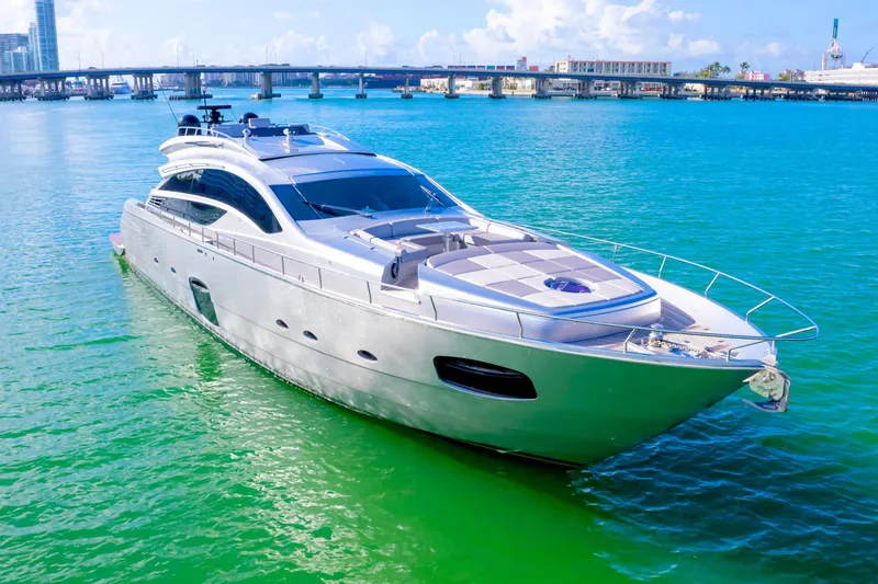 Slide: The Image of Luxury 2013 Pershing 82 yacht cruising on turquoise waters near a bridge. - 11