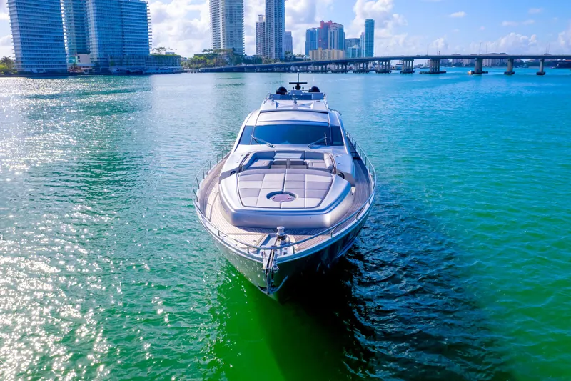 Slide: The Image of Luxurious 2013 Pershing 82 yacht cruising in a vibrant city waterfront. - 12