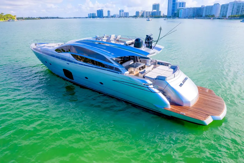 Slide: The Image of Luxurious 2013 Pershing 82 yacht cruising in clear turquoise waters near a city skyline. - 15