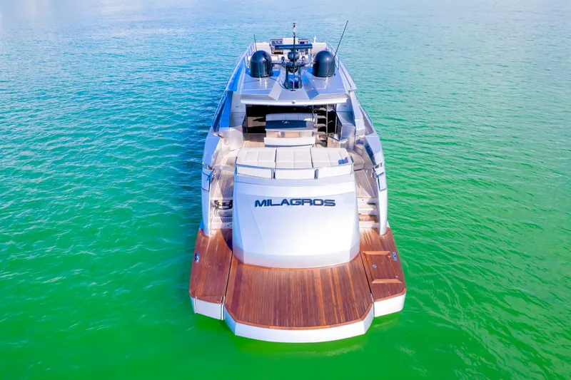 Slide: The Image of Luxury Pershing 82 yacht from 2013 on vibrant green water, rear view. - 16