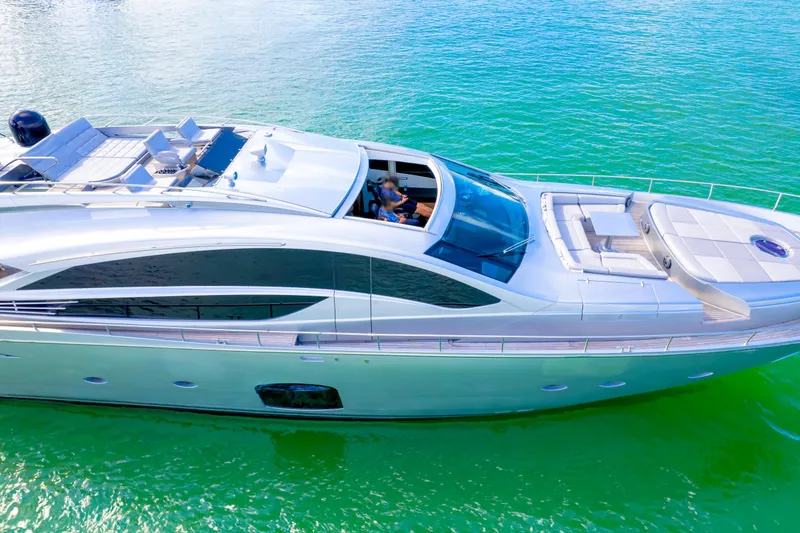 Slide: The Image of Luxury 2013 Pershing 82 yacht cruising on vibrant turquoise waters. - 17