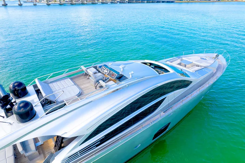 Slide: The Image of Luxurious 2013 Pershing 82 yacht on vibrant turquoise water, showcasing sleek design and spacious deck. - 18