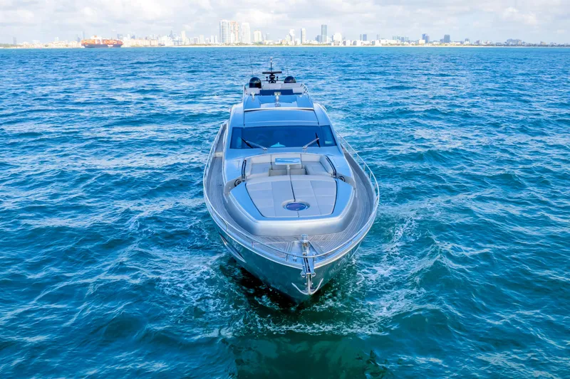 Slide: The Image of Luxury 2013 Pershing 82 yacht cruising on open water with city skyline in background. - 2