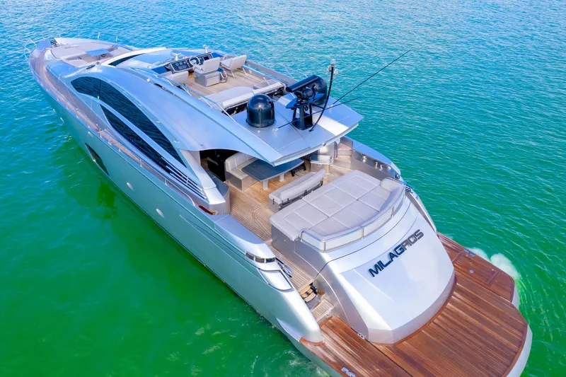 Slide: The Image of Luxurious 2013 Pershing 82 yacht cruising on clear turquoise waters. - 23