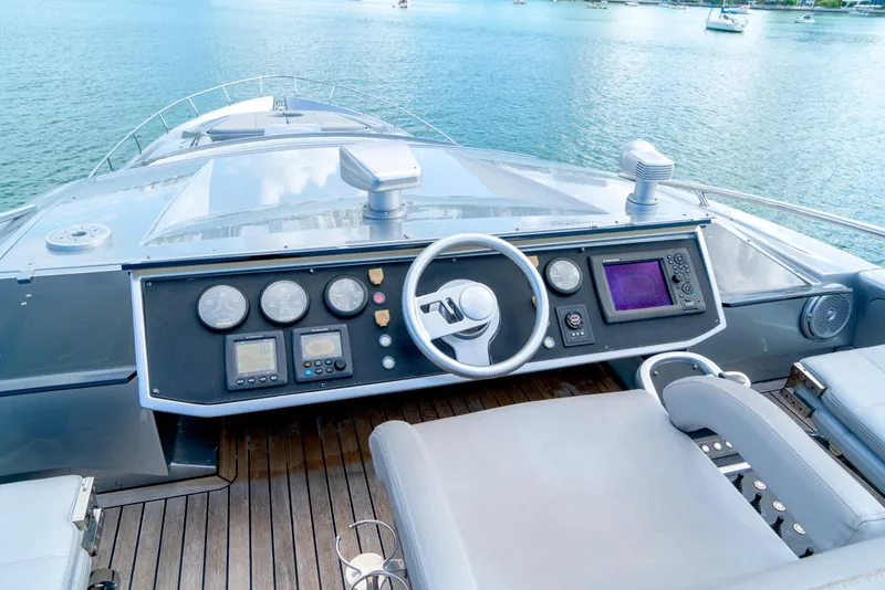 Slide: The Image of Cockpit of 2013 Pershing 82 yacht with modern controls and steering wheel. - 27