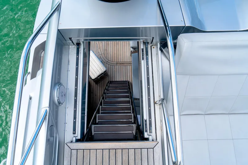 Slide: The Image of Staircase on 2013 Pershing 82 yacht, leading to lower deck with wooden flooring. - 30