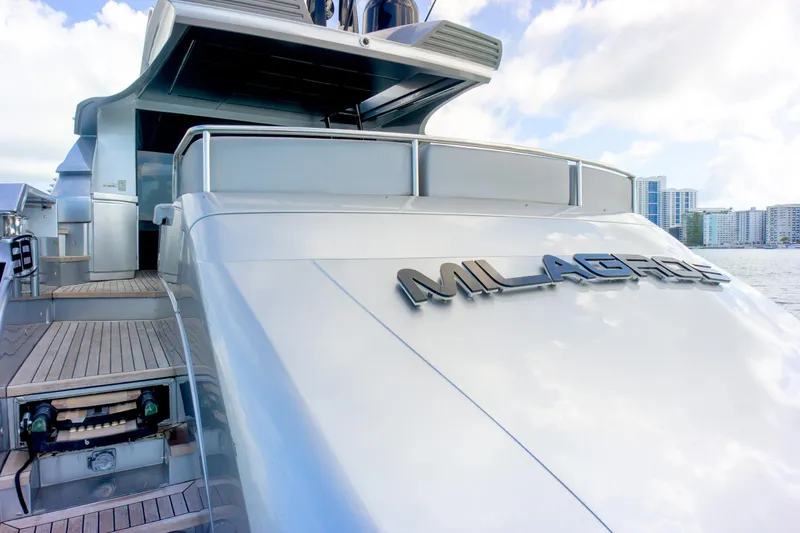 Slide: The Image of Luxury Pershing 82 yacht from 2013, docked with city skyline in background. - 34
