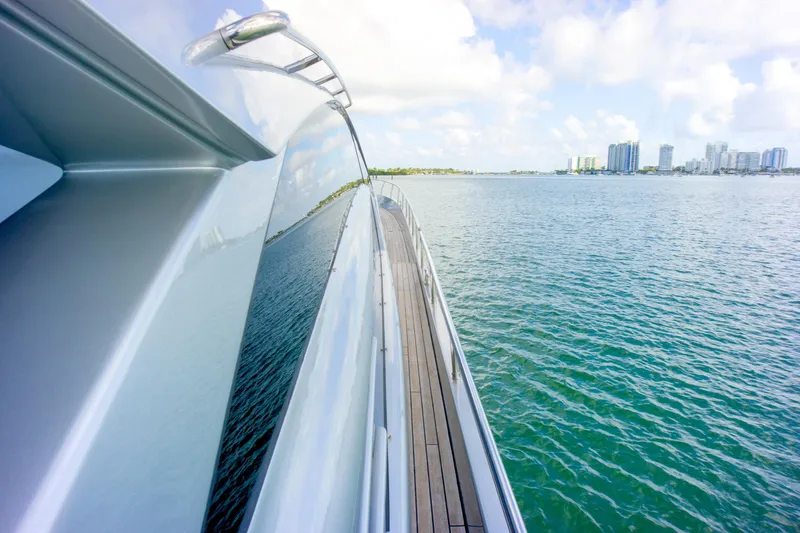 Slide: The Image of 2013 Pershing 82 yacht cruising on calm waters with city skyline in background. - 37