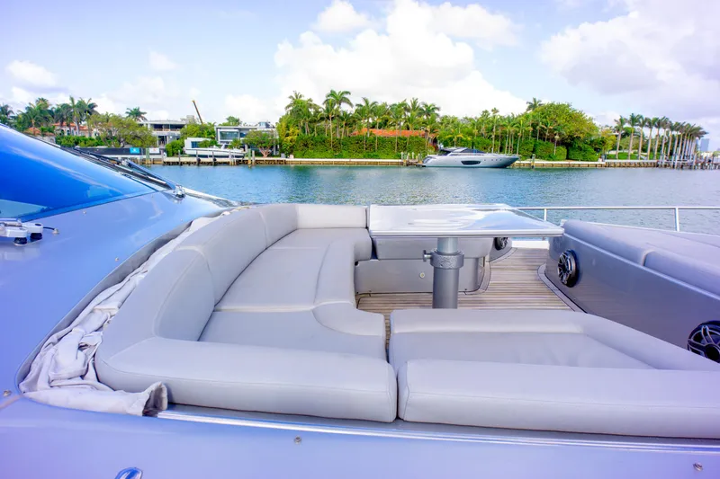 Slide: The Image of Luxurious seating area on 2013 Pershing 82 yacht, overlooking serene waterfront scenery. - 44