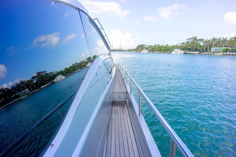 Slide: The Image of Side view of 2013 Pershing 82 yacht cruising on clear blue water. - 46