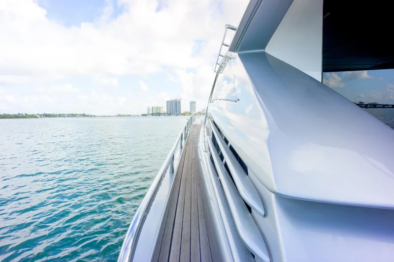 Slide: The Image of Luxury Pershing 82 yacht cruising on calm waters, 2013 model, with city skyline in background. - 48