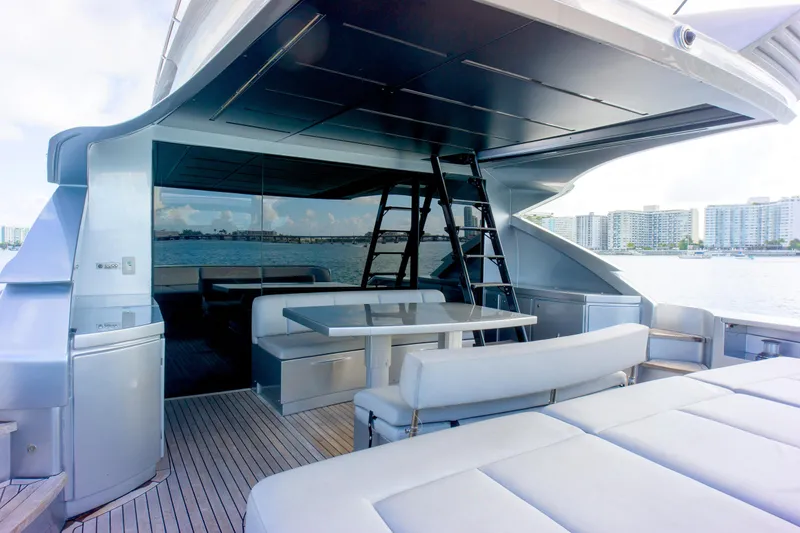 Slide: The Image of Luxurious 2013 Pershing 82 yacht deck with seating, table, and ocean view. - 49