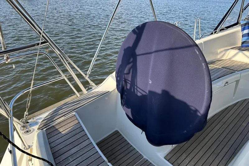 Slide: The Image of 2008 Jeanneau Sun Odyssey 42 DS sailboat cockpit with blue wheel cover, on calm water. - 10