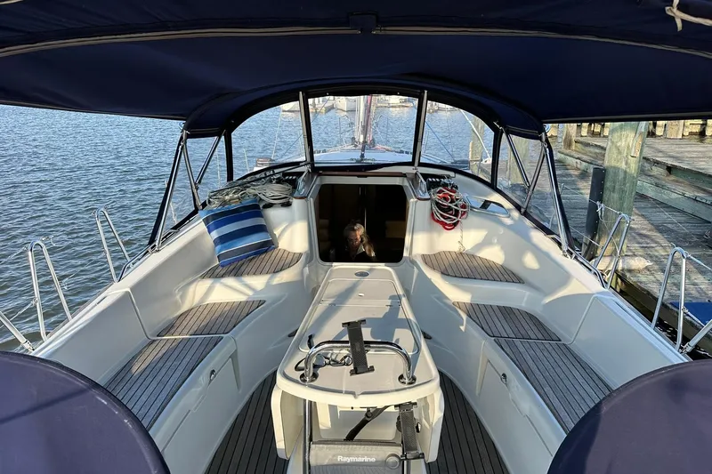Slide: The Image of 2008 Jeanneau Sun Odyssey 42 DS sailboat cockpit with canopy, docked by the water. - 11