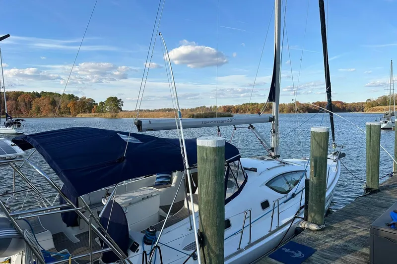 Slide: The Image of 2008 Jeanneau Sun Odyssey 42 DS sailboat docked by a scenic lake. - 15